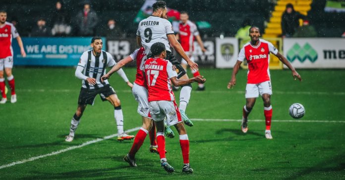 Kyle Wootton rises highest to puts Notts in front against Wrexham.