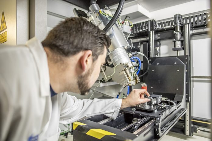 An engineer testing a 3D printing setup at the CfAM. Photo via the University of Nottingham. 